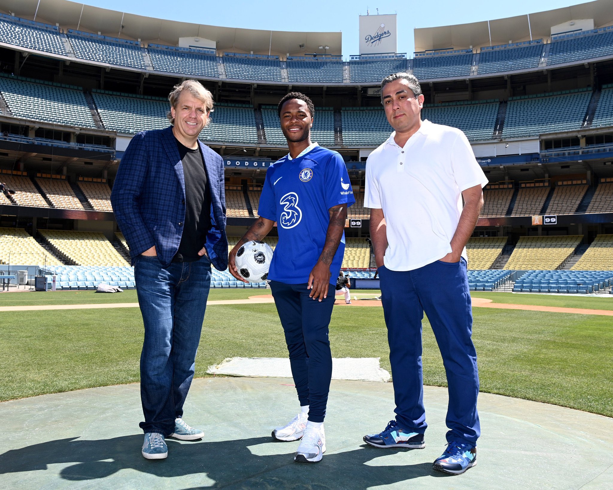 Todd Boehly and Behdad Eghbali stand with Raheem Sterling.