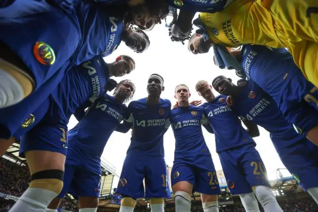 Chelsea players in a group huddle.