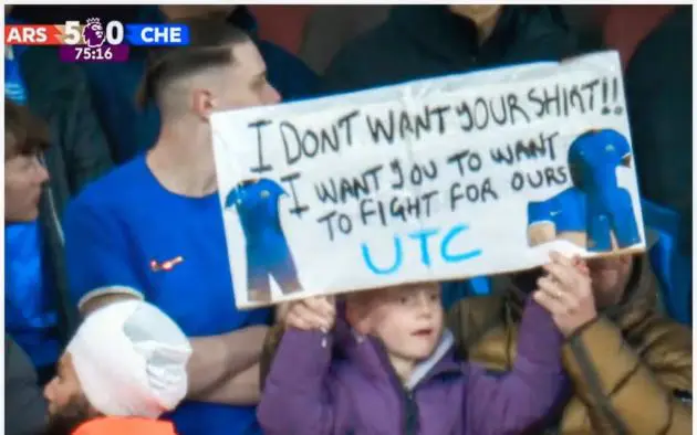 Chelsea fan holding up sign