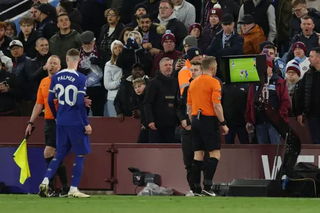 The referee checks the VAR monitor.