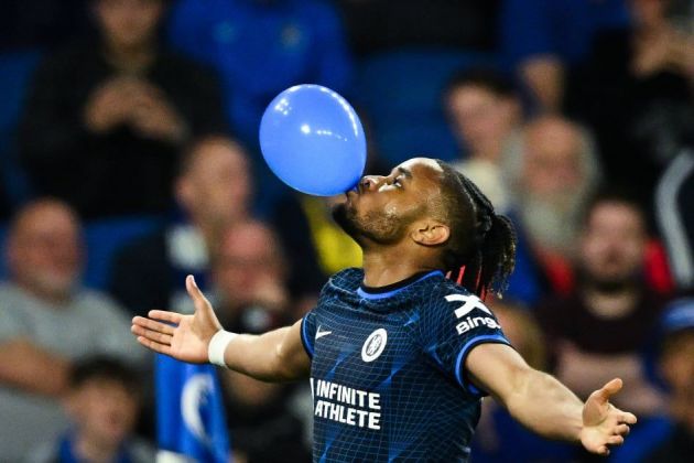 Christopher Nkunku blows a balloon.