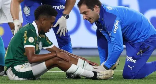 Estevao Willian sits injured after twisting his ankle.