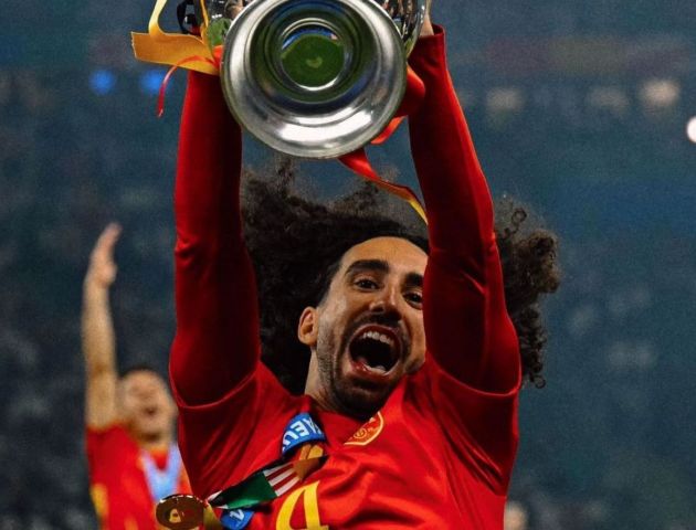 Marc Cucurella lifts the Euros trophy.