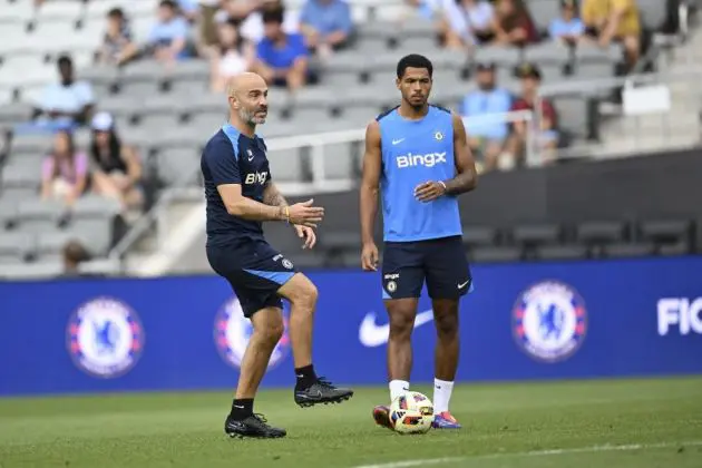 Levi Colwill learning from Enzo Maresca on the training pitch.