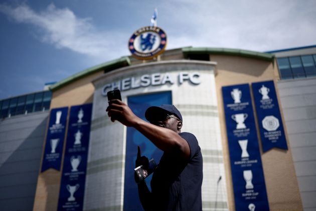 A Chelsea fans takes a generic photo outside Stamford Bridge. (Photo by HENRY NICHOLLS / AFP)