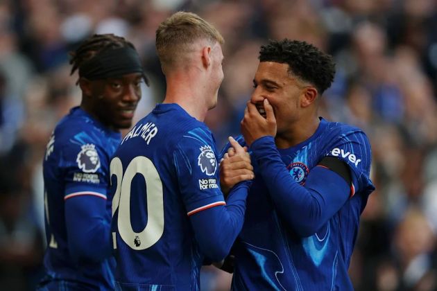 Cole Palmer and Jadon Sancho clasp hands after linking up. (Photo by Richard Heathcote/Getty Images)