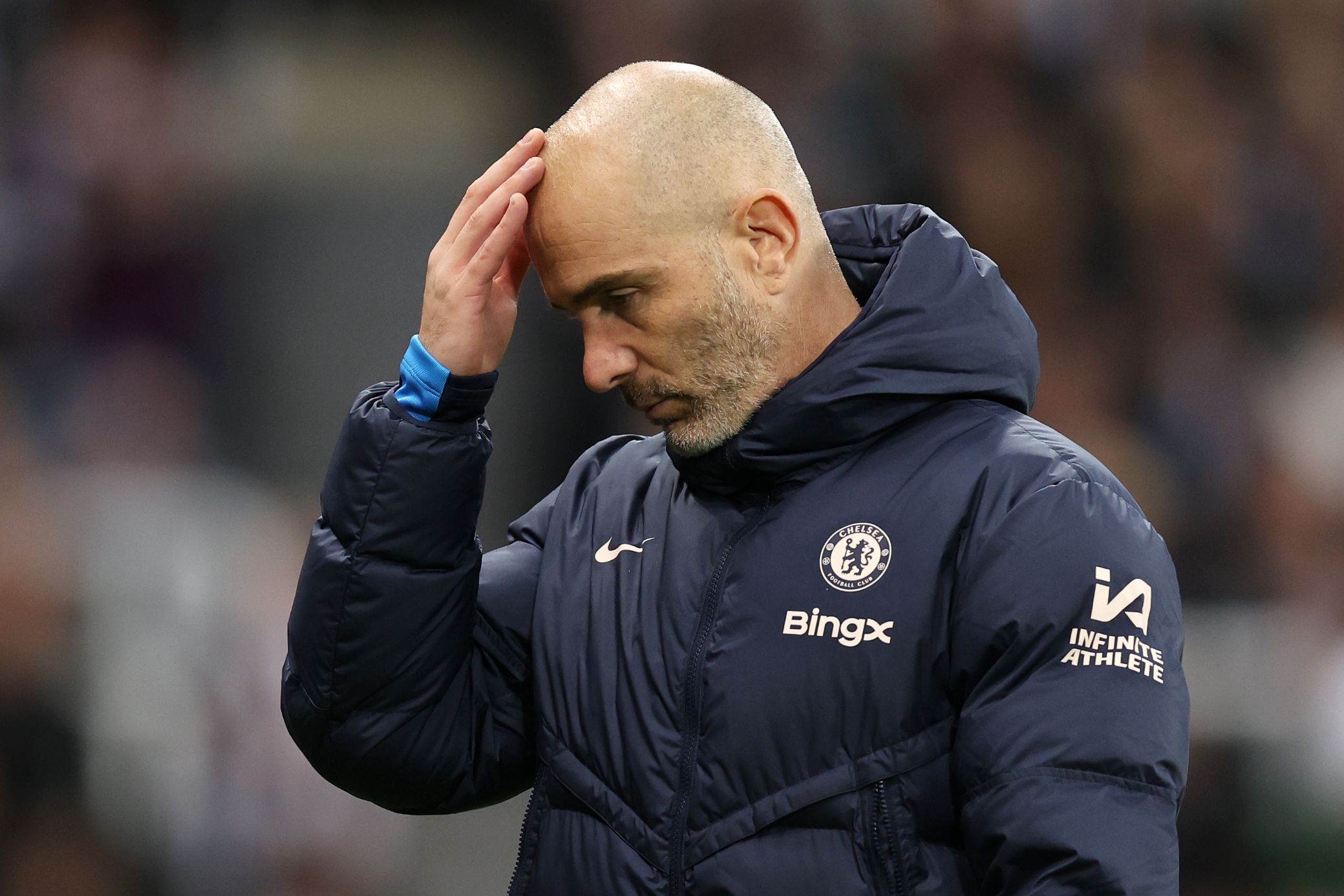 Enzo Maresca touches his brow after Newcastle defeat. (Photo by George Wood/Getty Images)