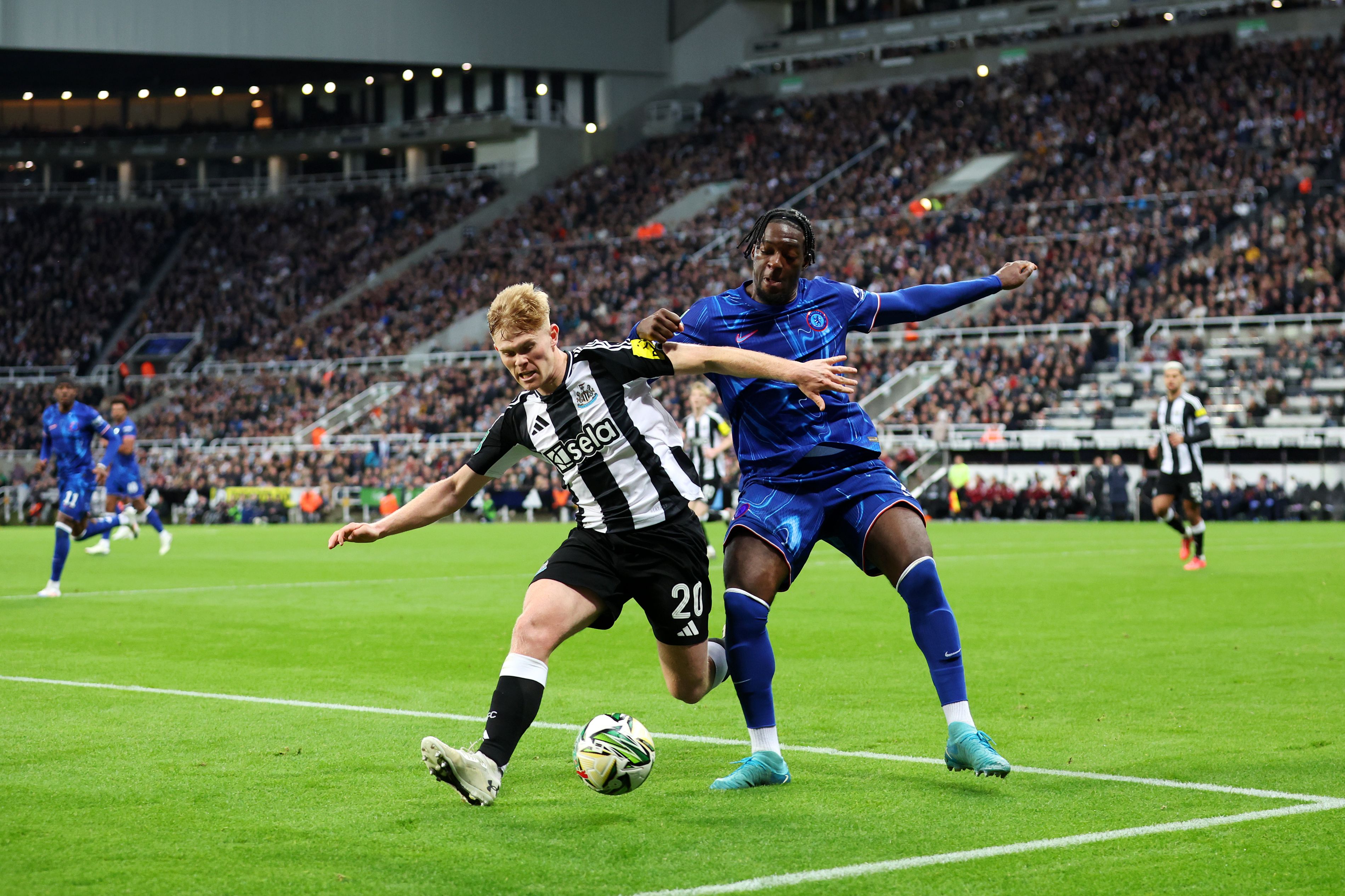 Lewis Hall battles for the ball with Axel Disasi at St James' Park. (Photo by Ed Sykes/Getty Images)