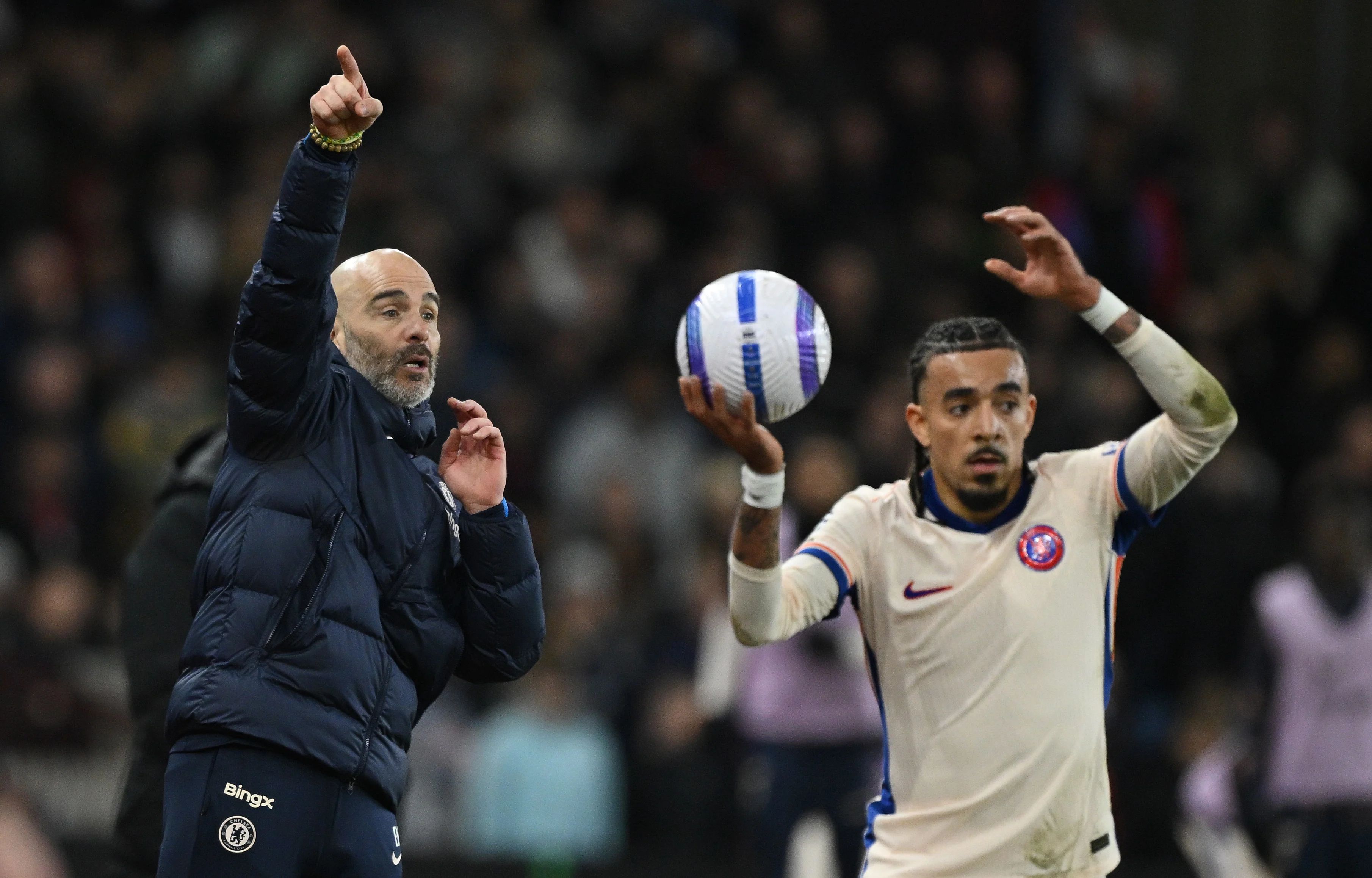 Malo Gusto takes a throw in in front of Enzo Maresca. (Photo by Chris Lee/Chelsea FC)