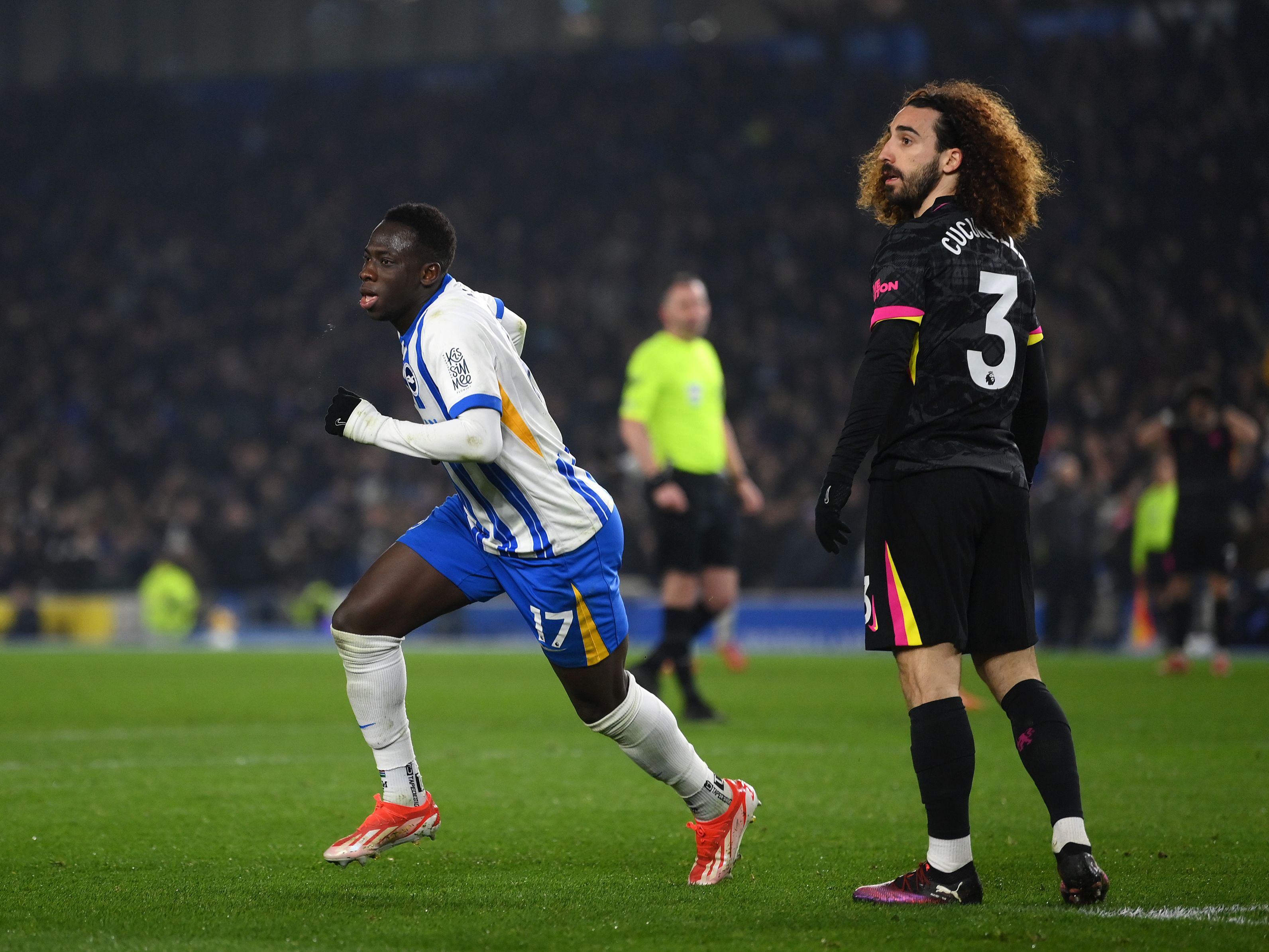 Yankuba Minteh wheels away from Marc Cucurella after scoring Brighton's third goal.