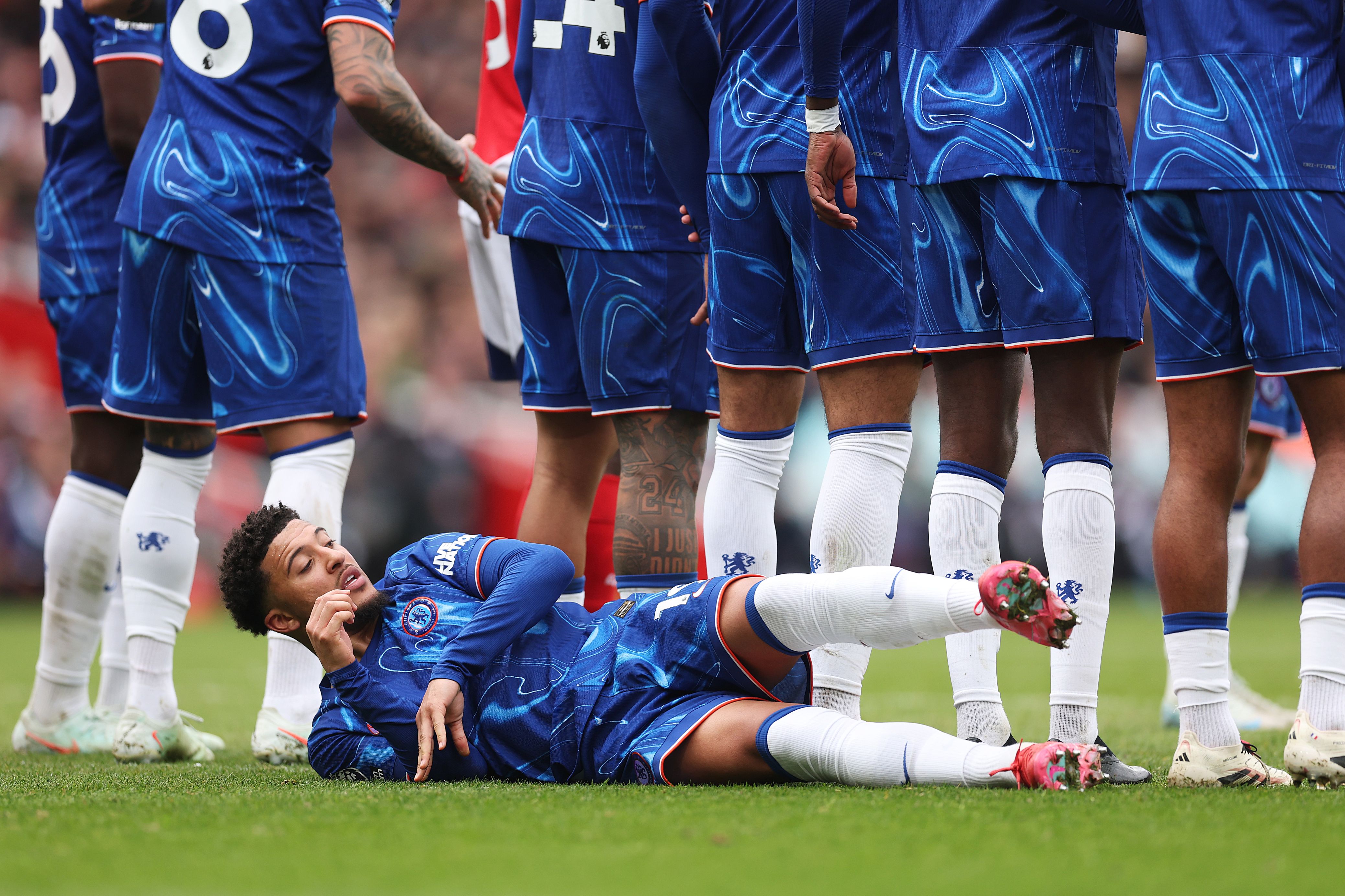 Jadon Sancho lies as part of a wall in a defeat at Arsenal.