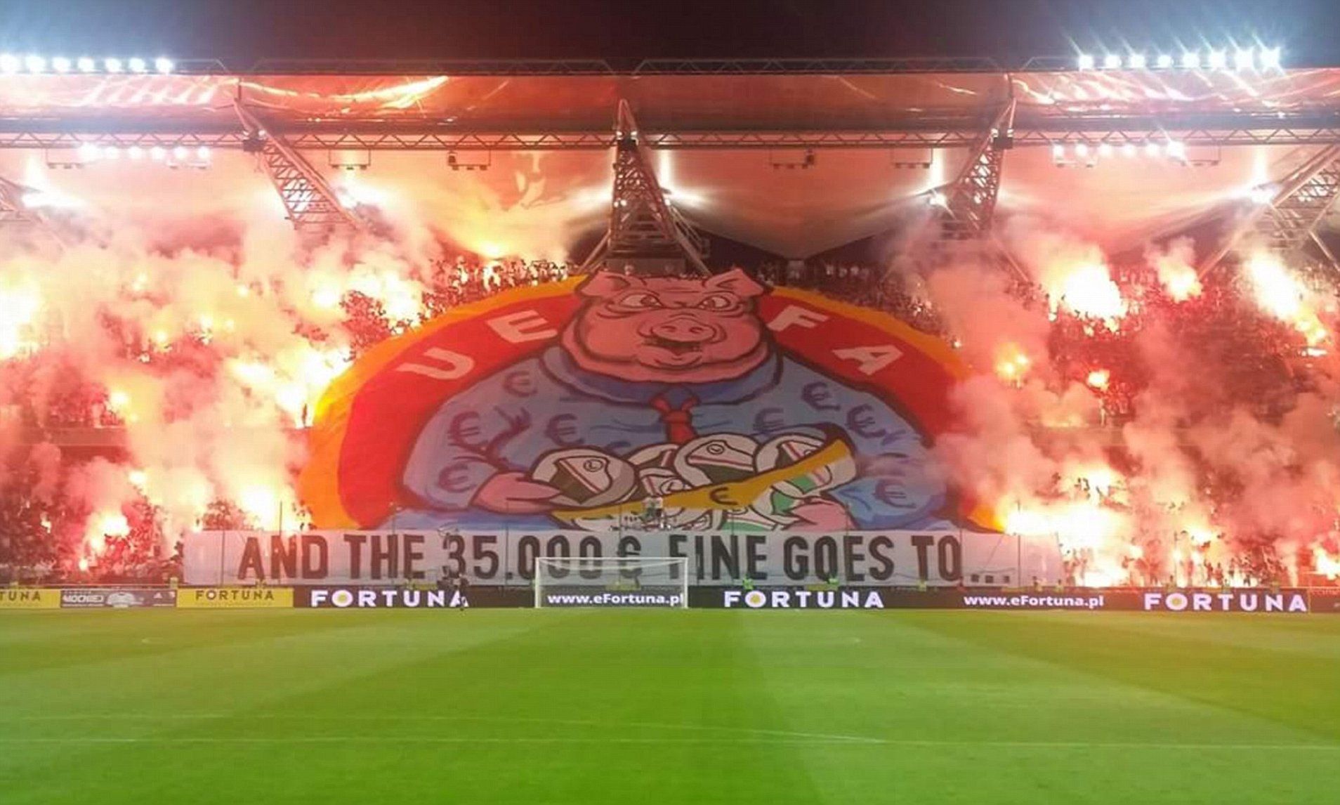 A Legia Warsaw banner showing UEFA as greedy pigs.