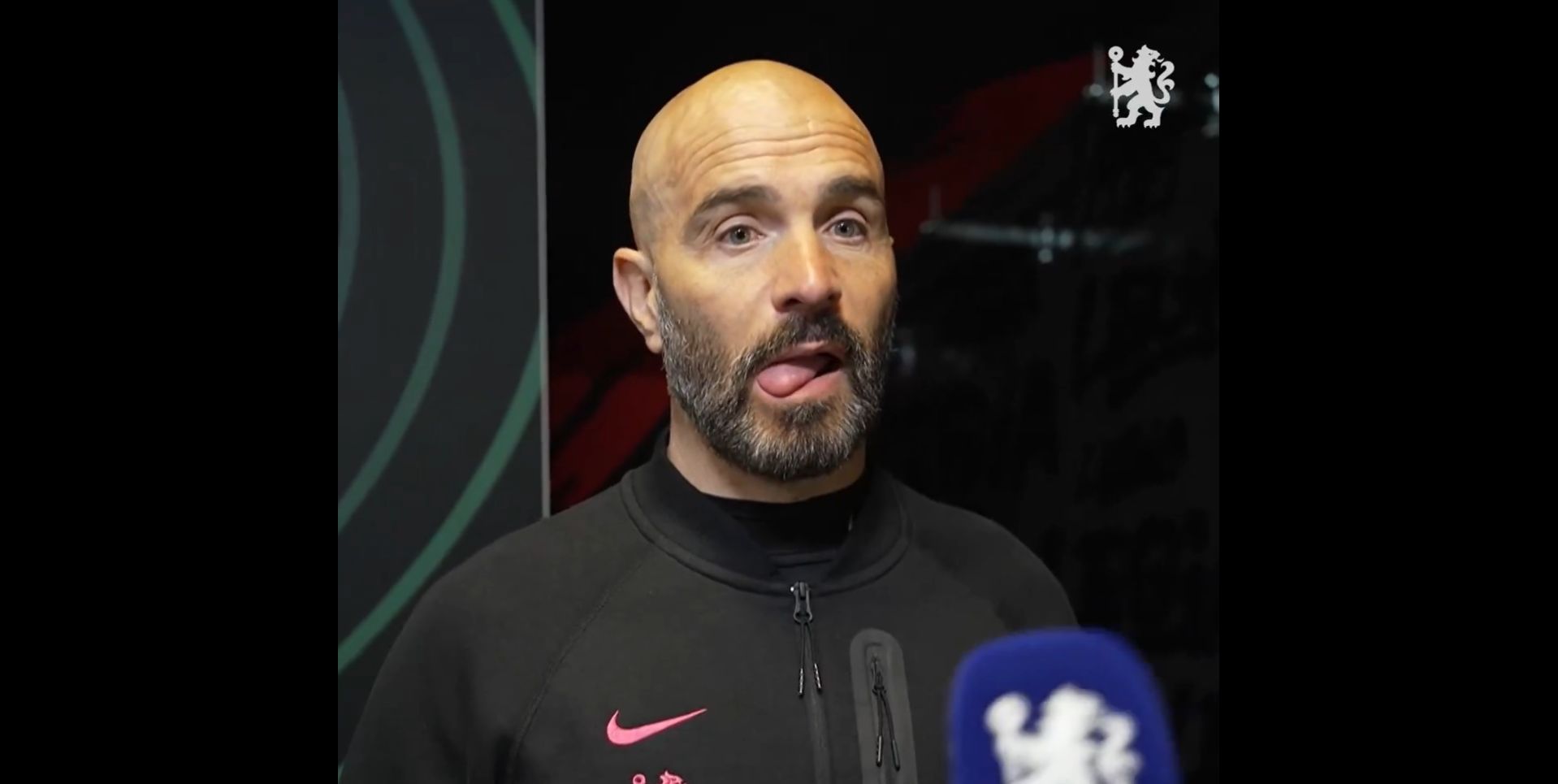 Enzo Maresca speaks to Chelsea TV with his tongue out.