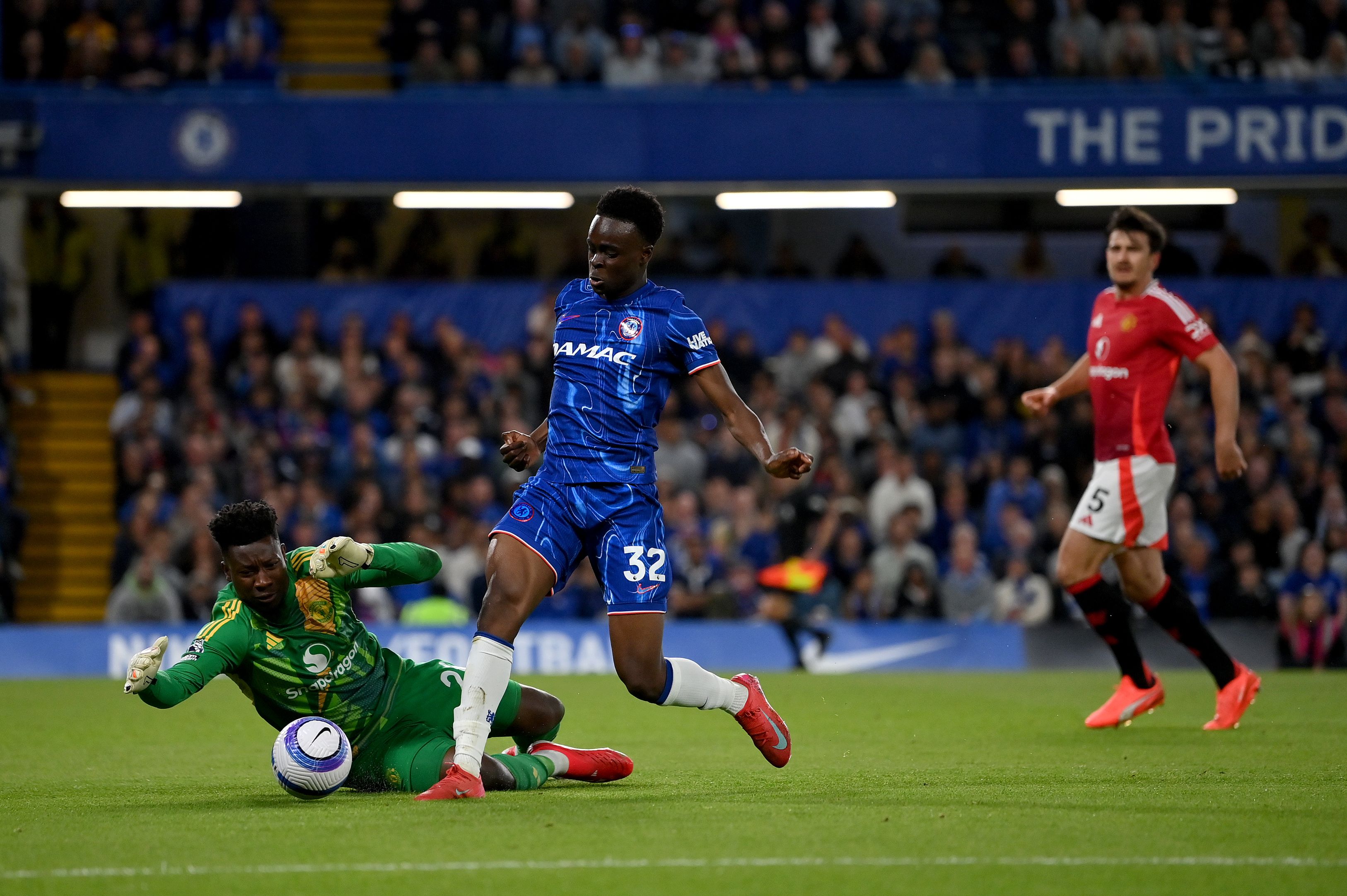 Tyrique George battles for possession against Manchester United.