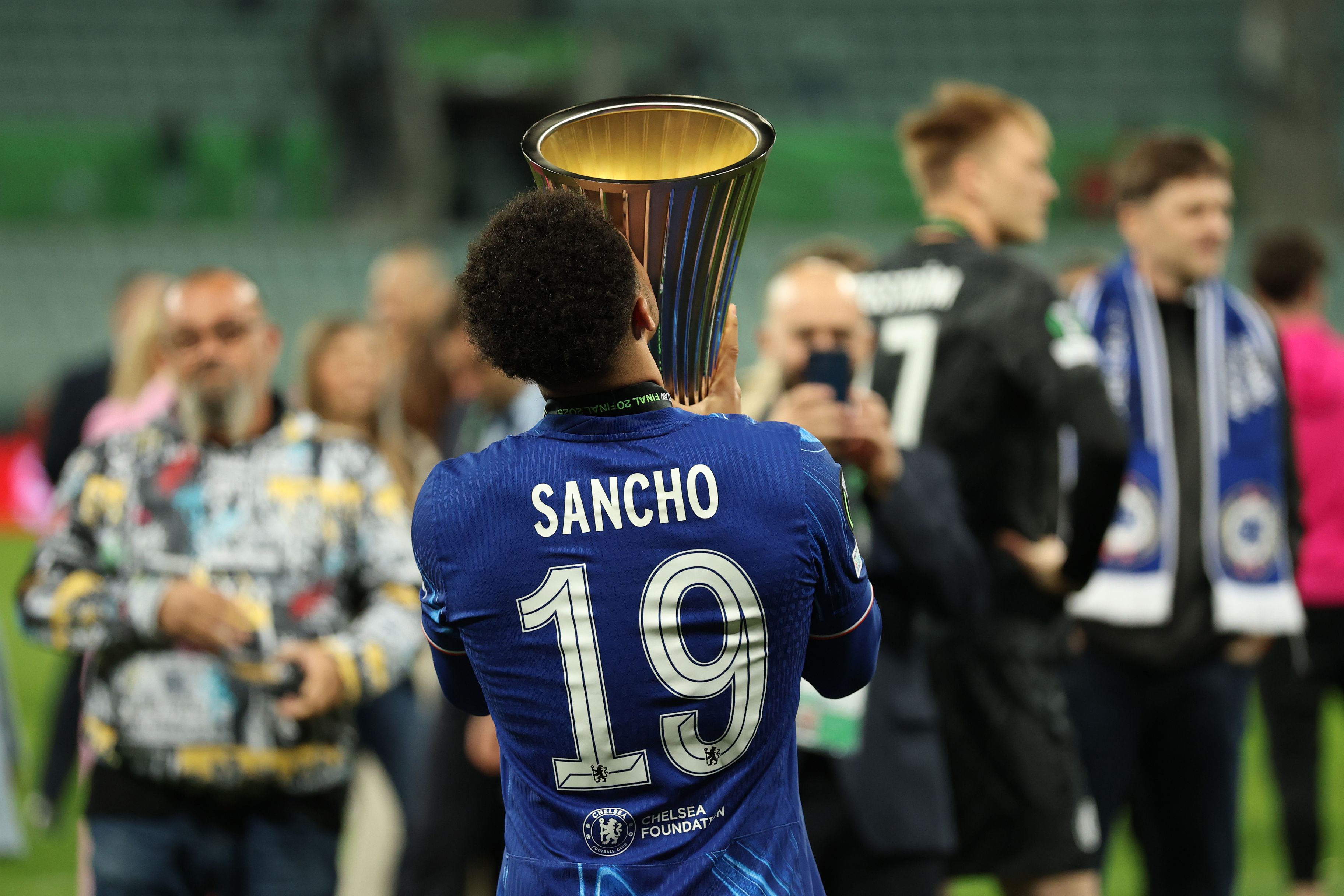 Jadon Sancho celebrates with the Conference League trophy.