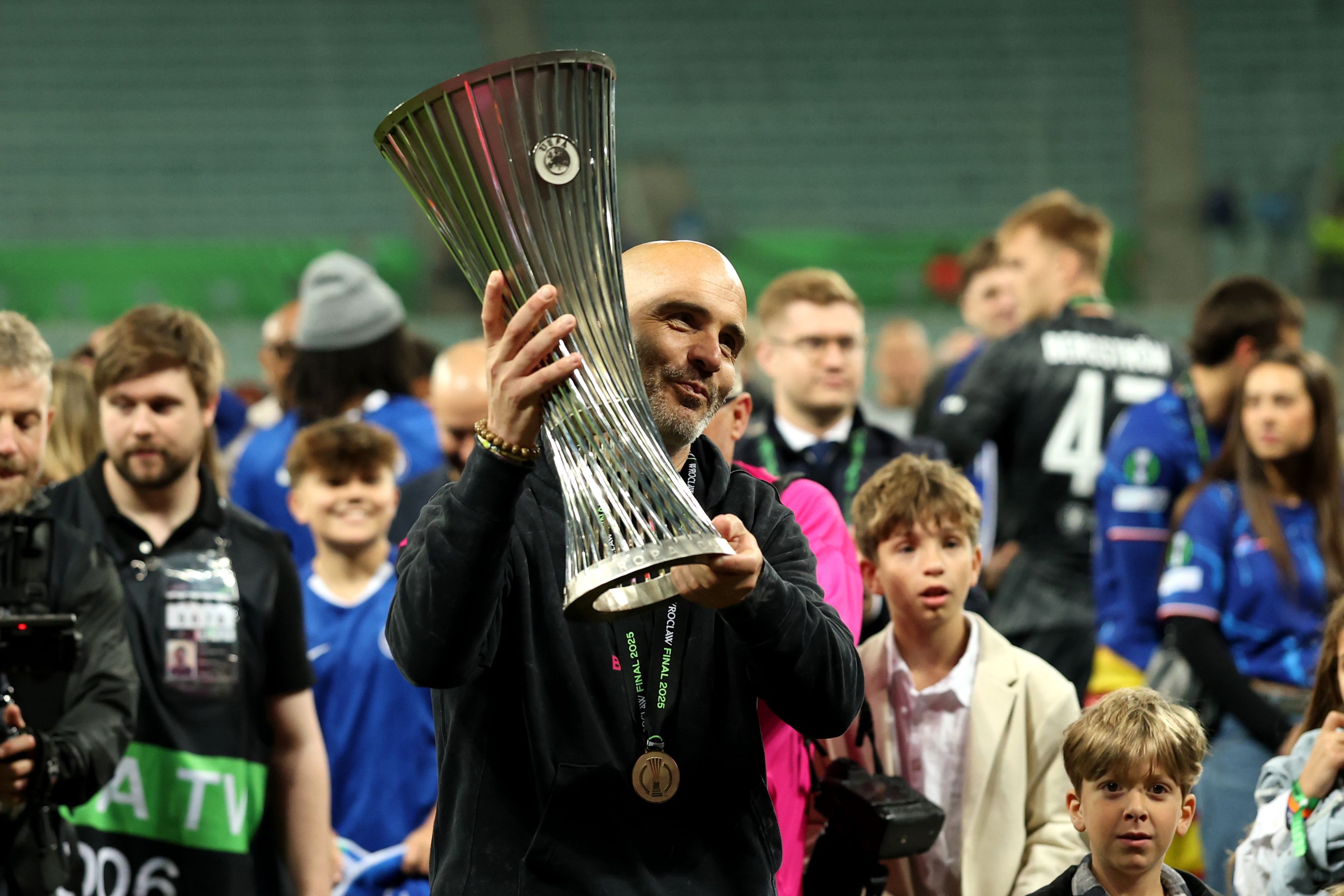 Enzo Maresca celebrates with the Conference League trophy.