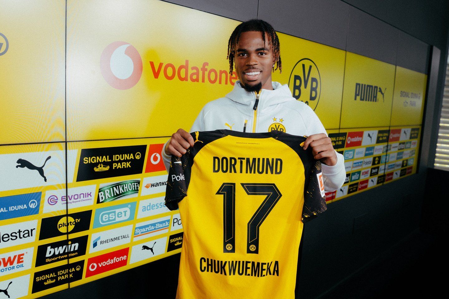 Carney Chukwuemeka holds up a Dortmund shirt ahead of his permanent transfer.