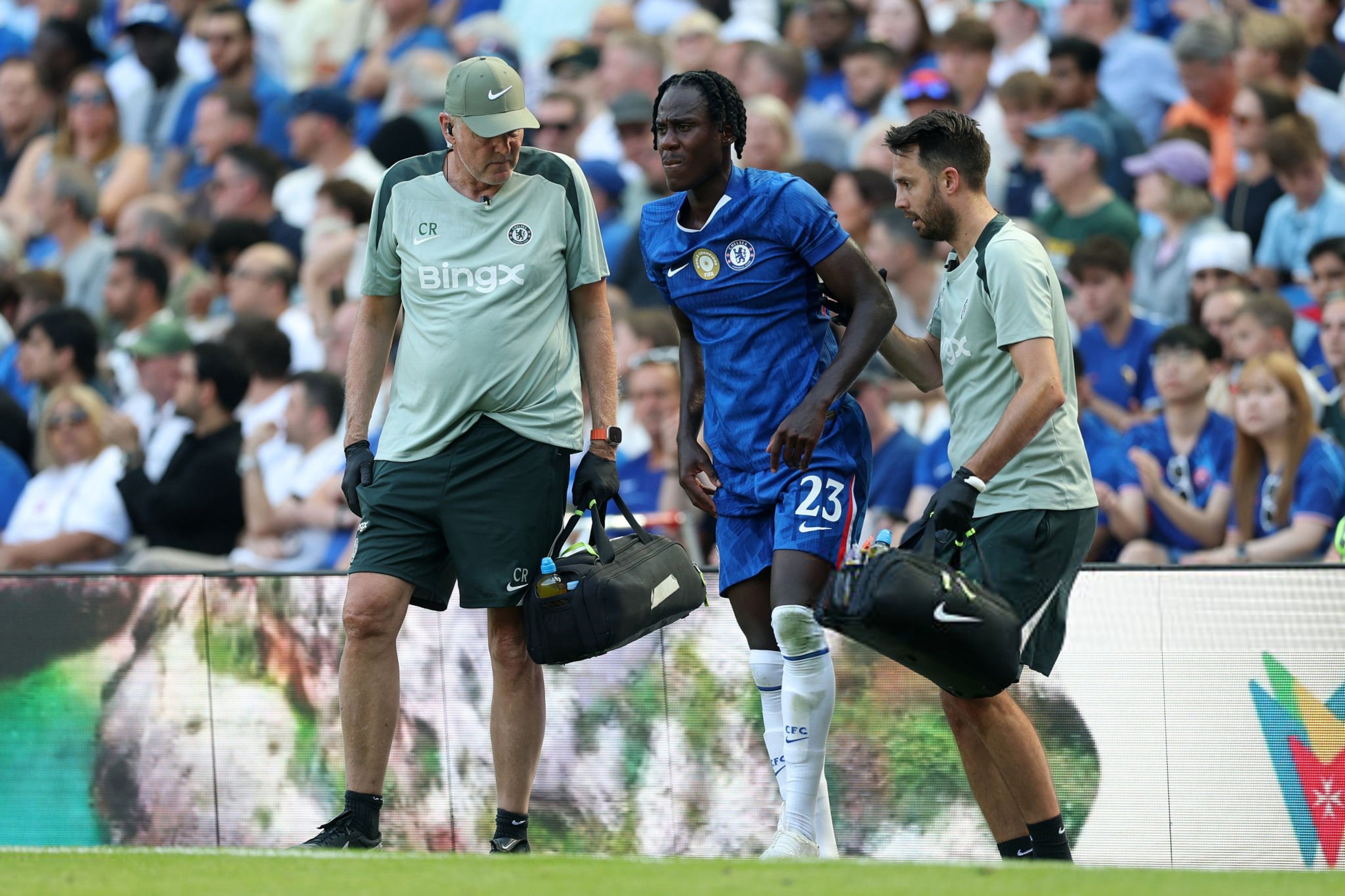 Trevoh Chalobah winces in pain as he puts weight on his injured ankle in a preseason friendly against AC Milan.