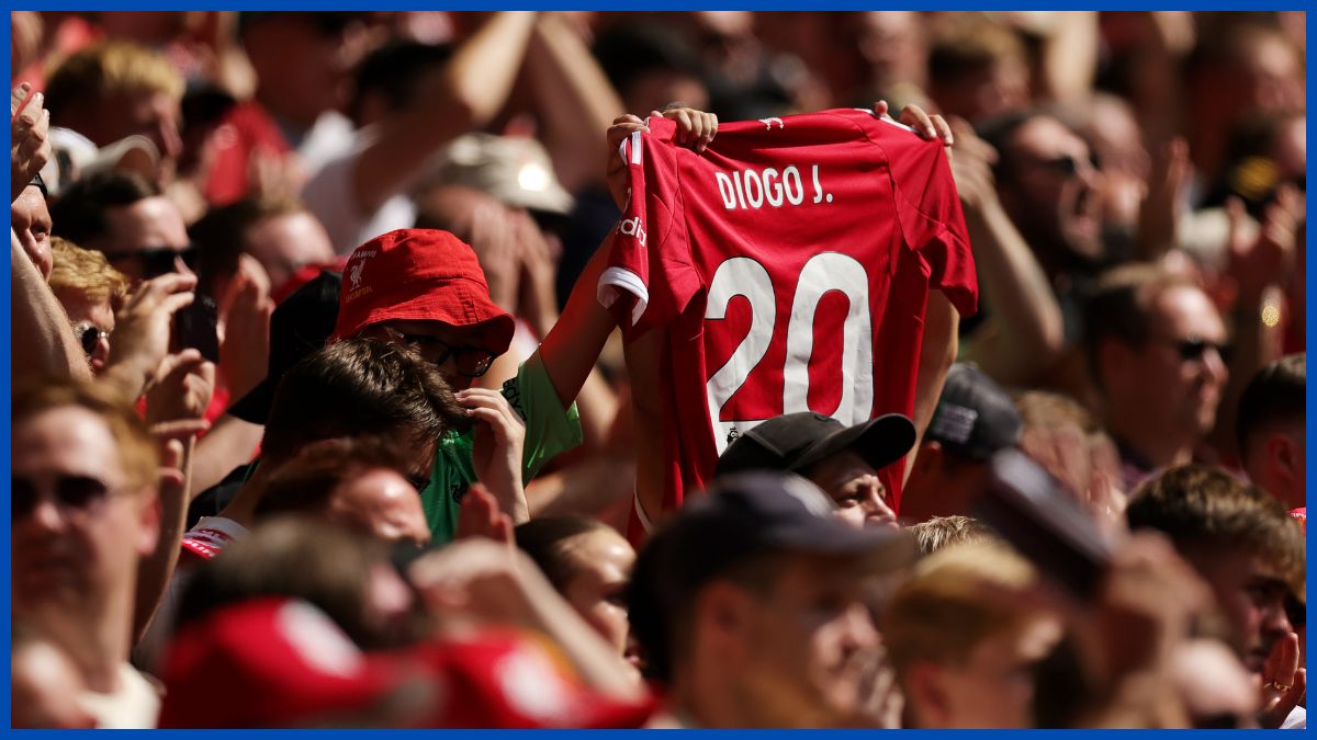 Diogo Jota's shirt held up by a Liverpool fan.