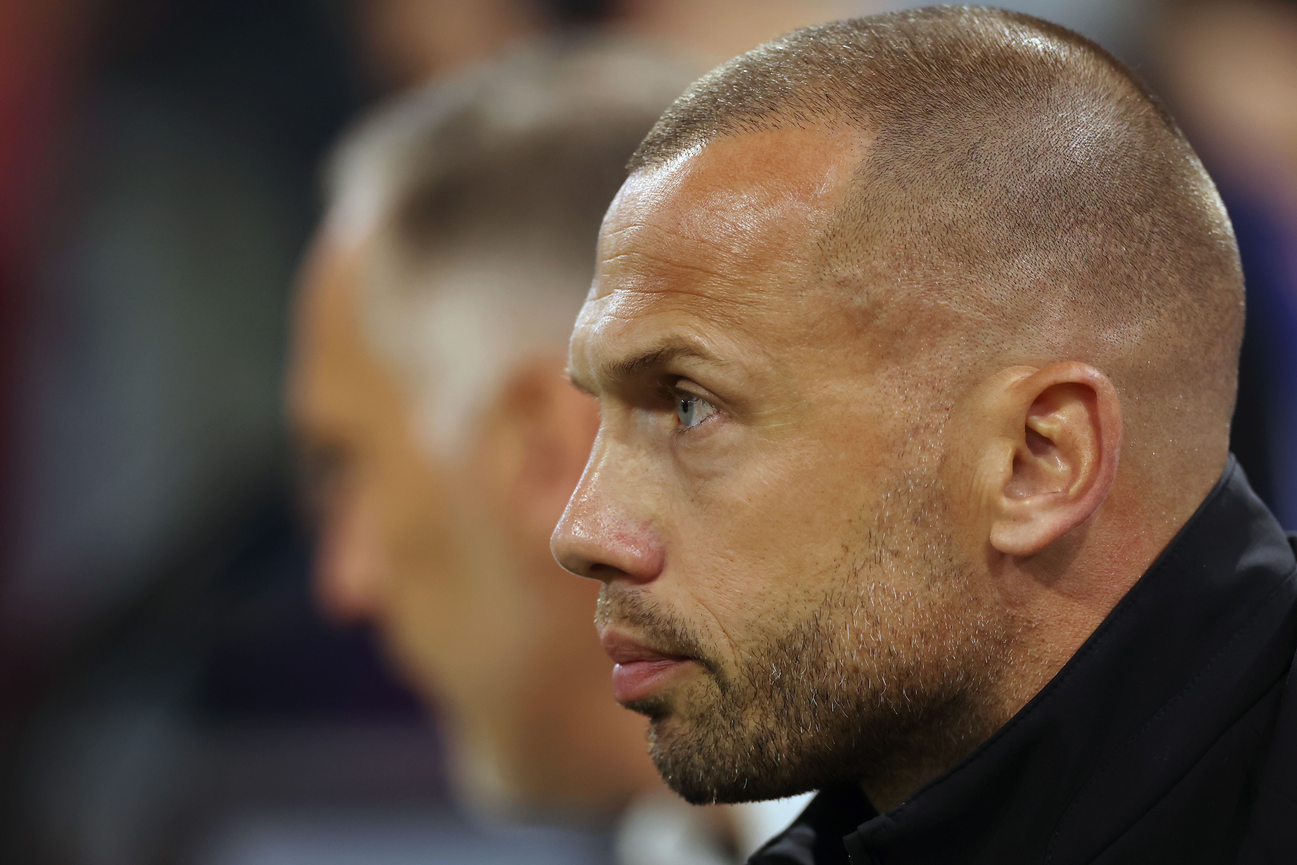 John Heitinga looks on from the touchline.