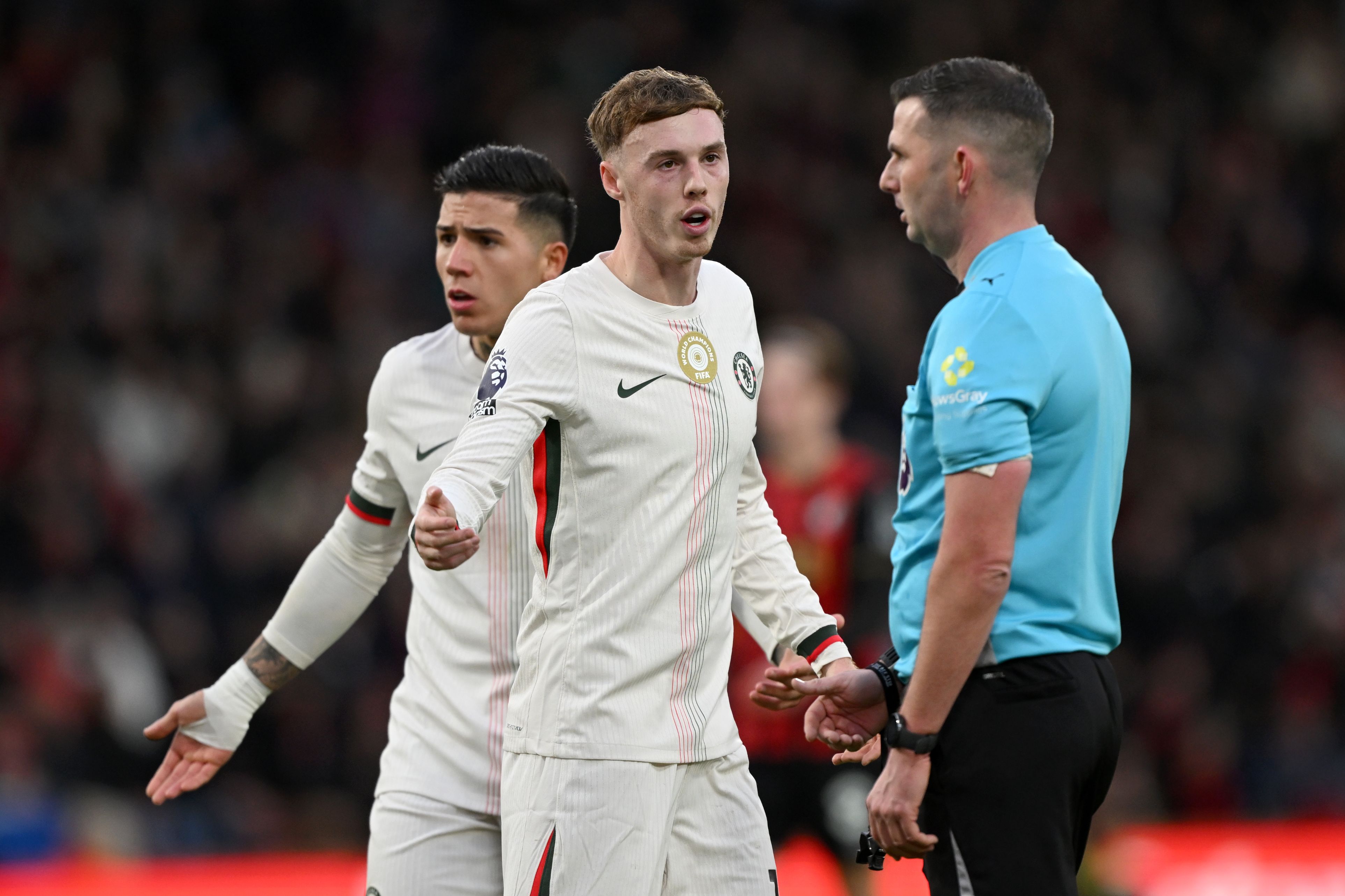 Cole Palmer speaks to a referee.