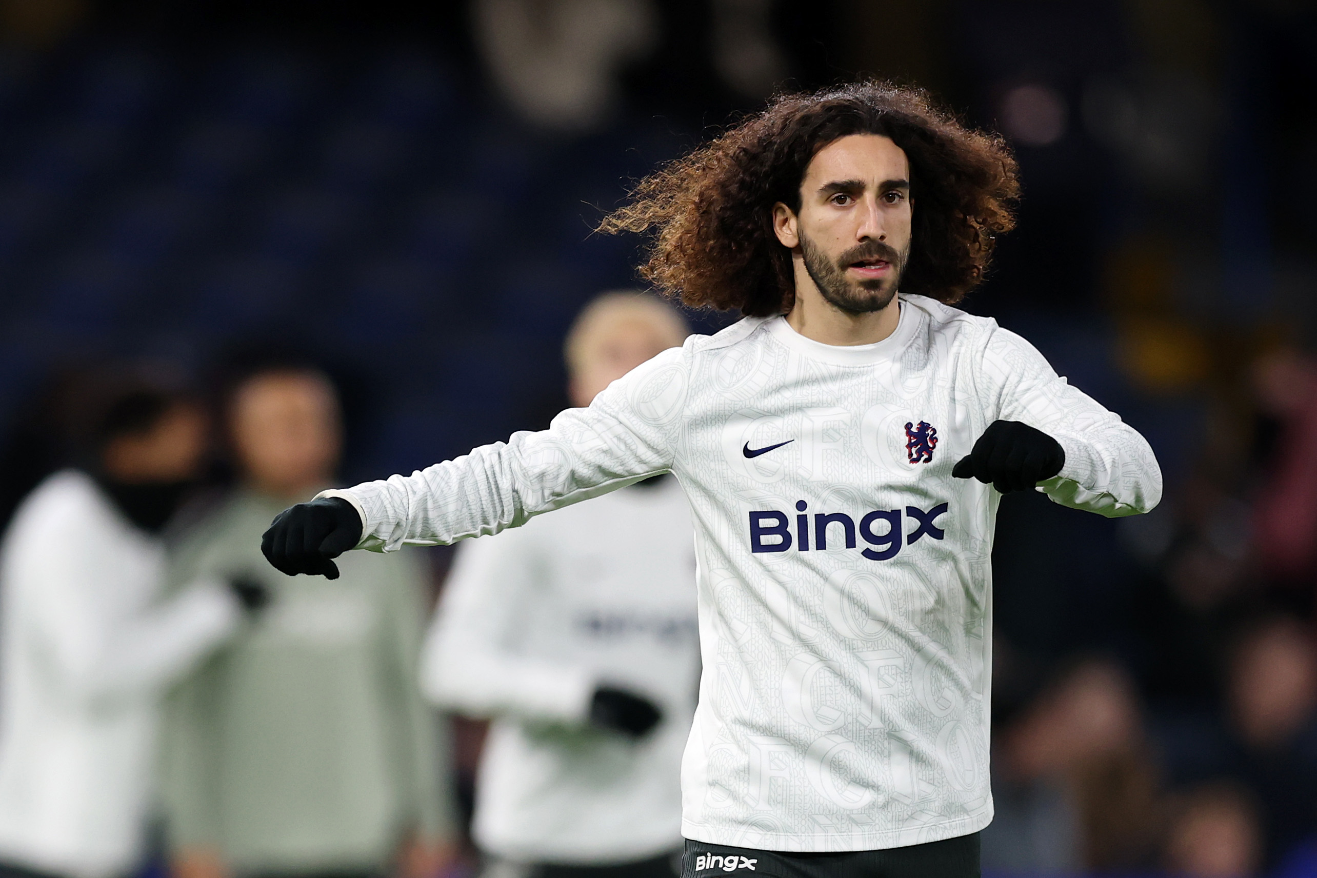 Marc Cucurella warms up for Chelsea.