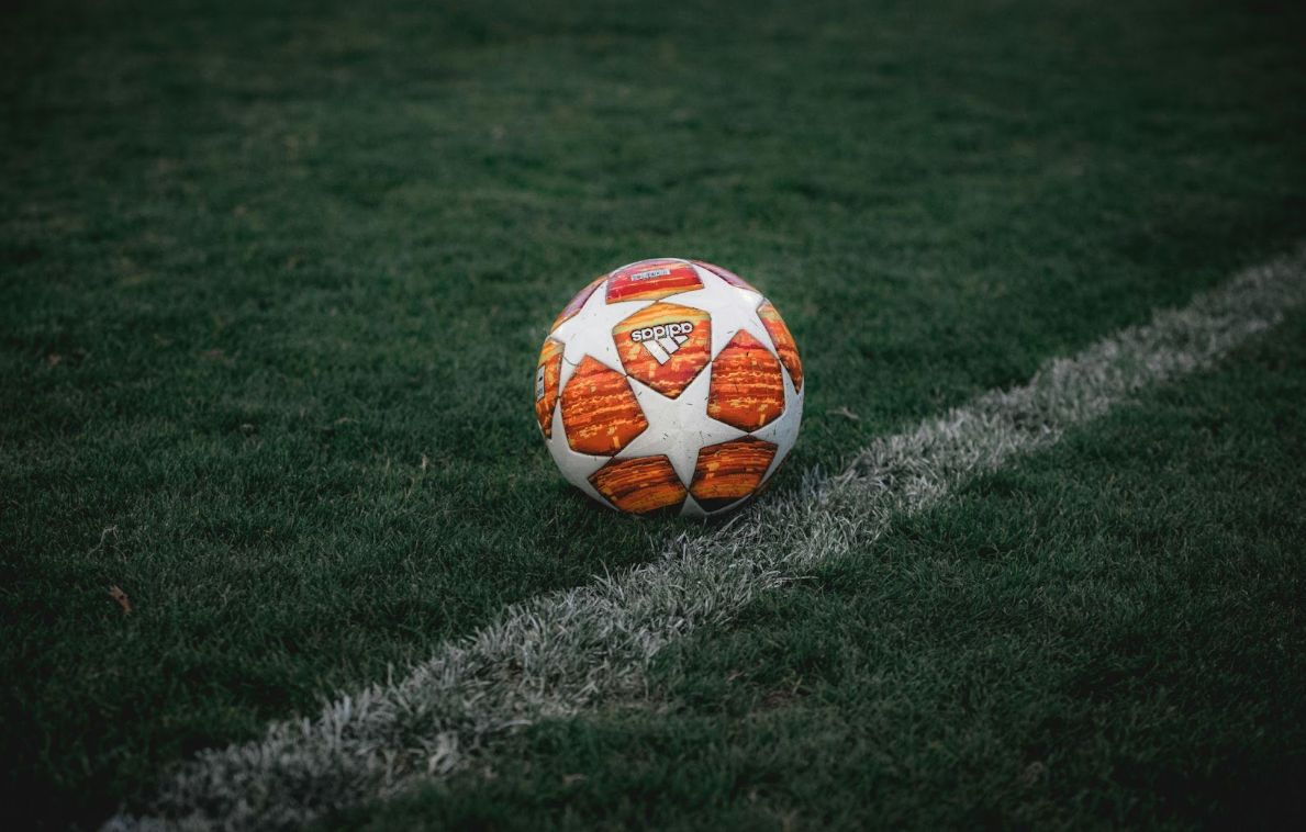 Champions League ball on the grass.