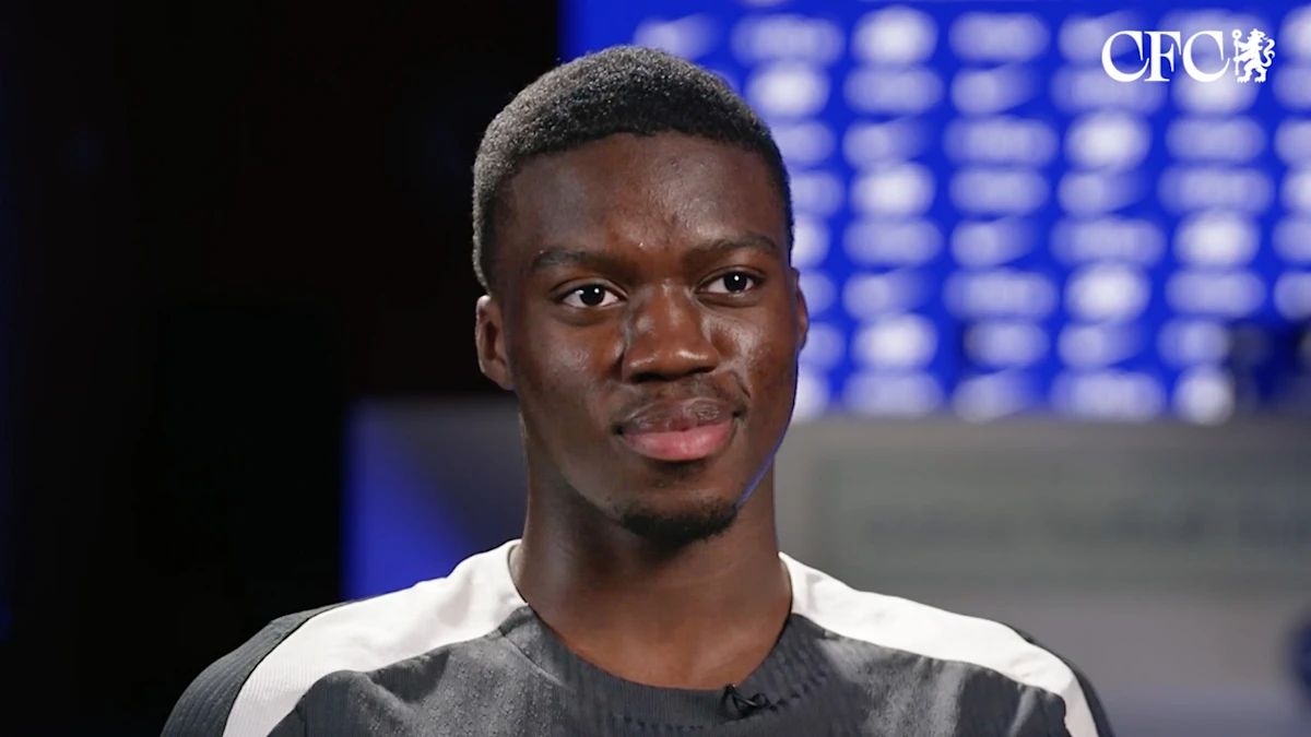 Mamadou Sarr speaks to the cameras at Chelsea HQ.