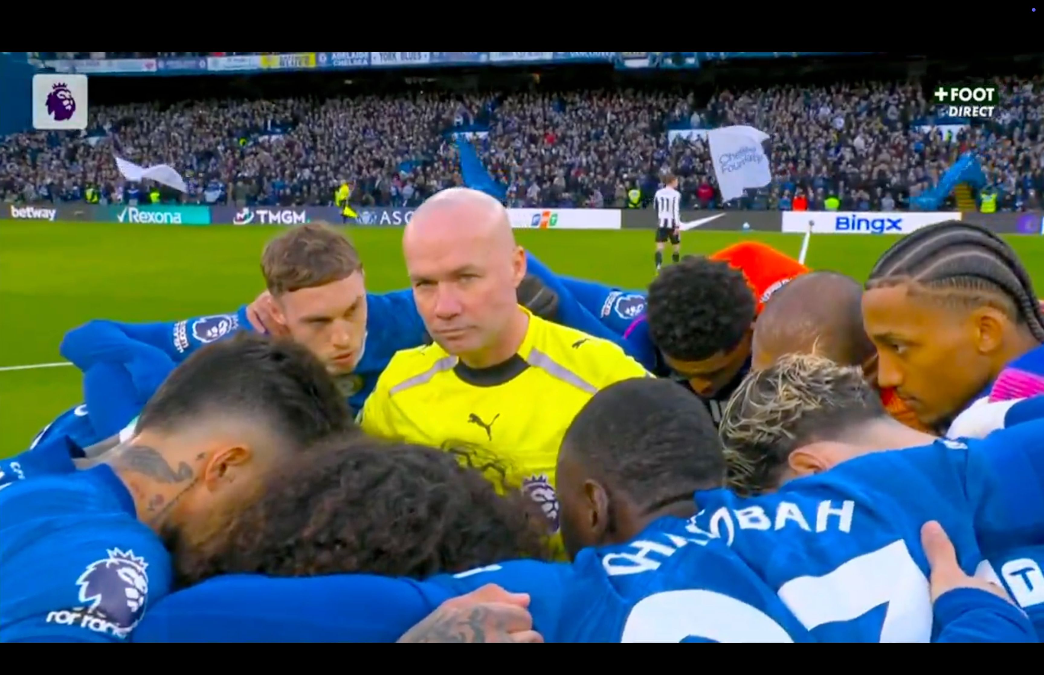 Paul Tierney finds himself in the middle of the Chelsea huddle.