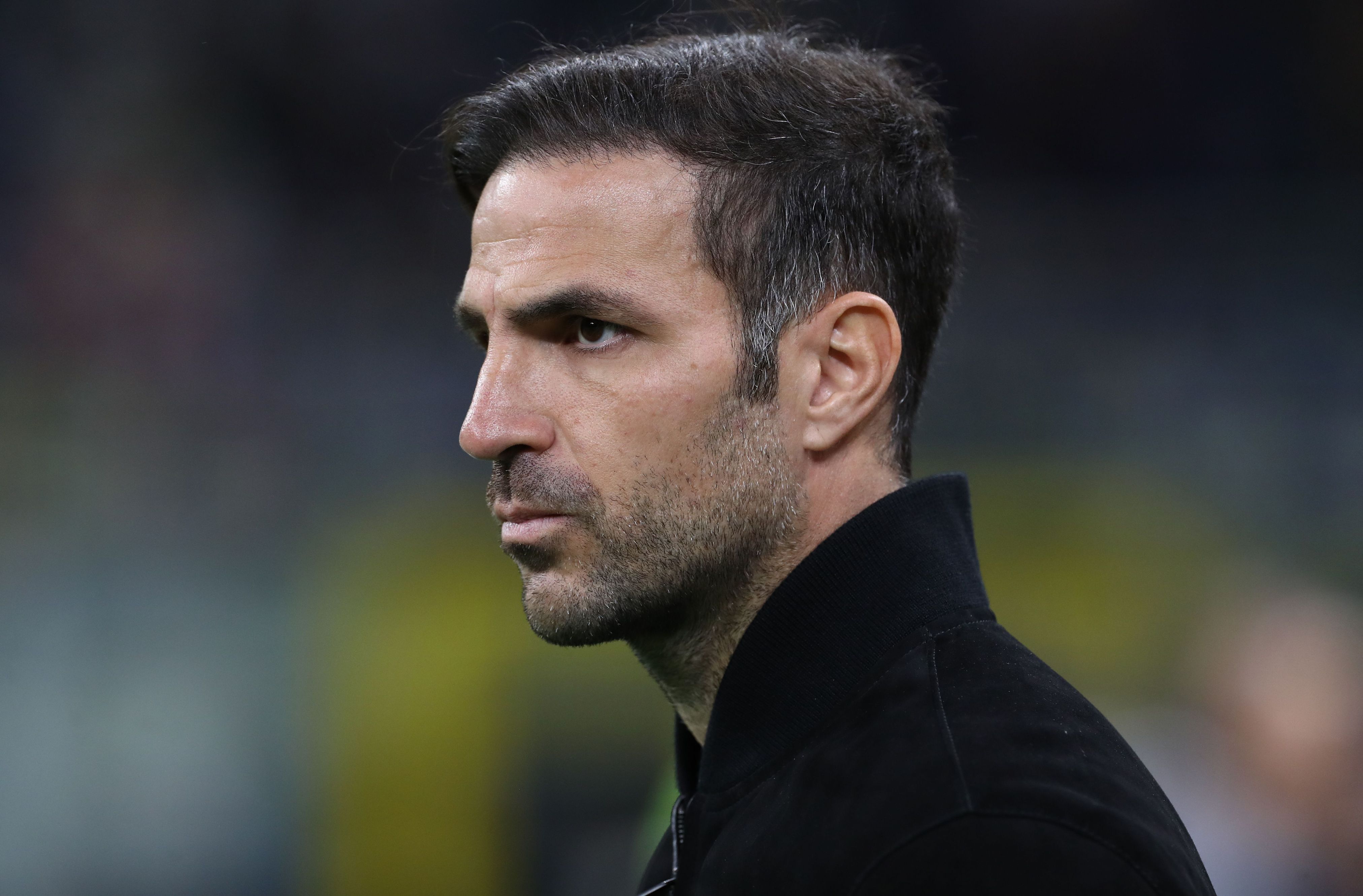 Cesc Fabregas looks on from the touchline.