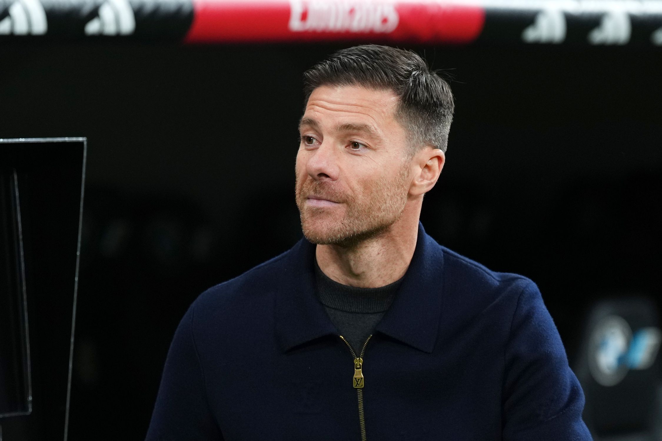 Xabi Alonso looks on from the touchline.