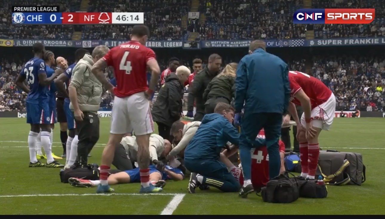 Jesse Derry is treated on the pitch at Stamford Bridge.